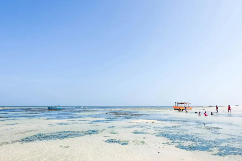 People and boats along the beach in Malindi, Kenya
